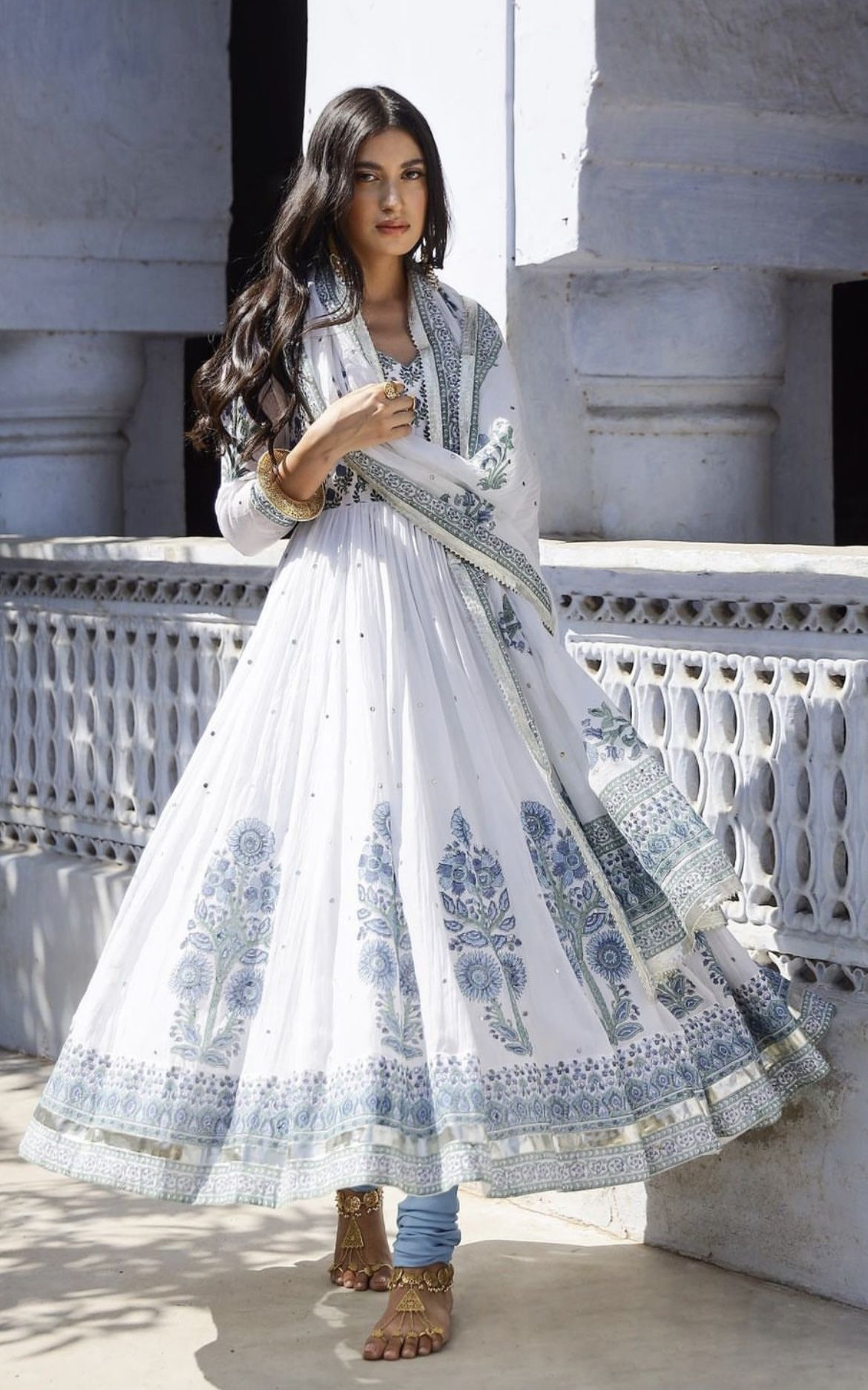 White embroidered garment photographed in natural light; editorial reference